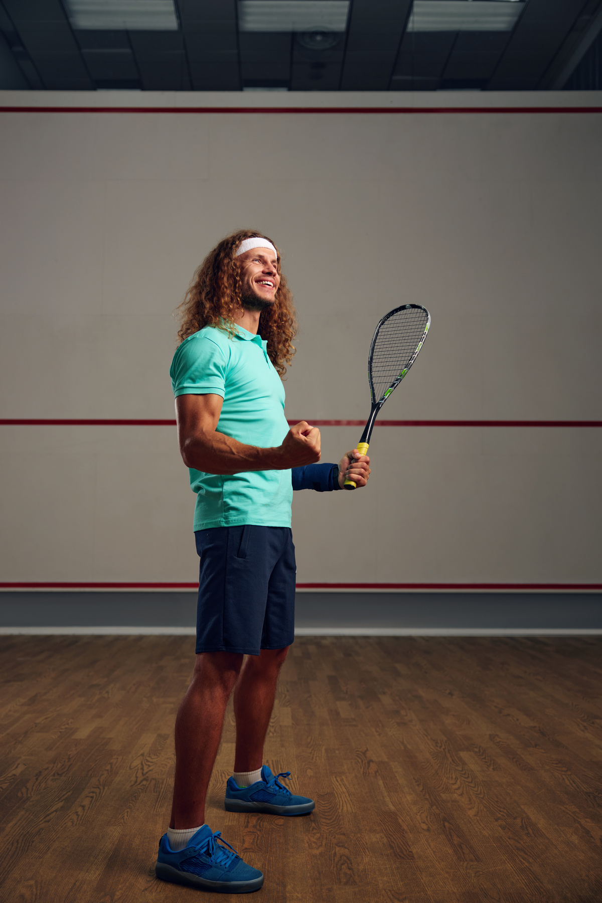 Satisfied Squash Player Clenching Fist Rejoicing Win in Game