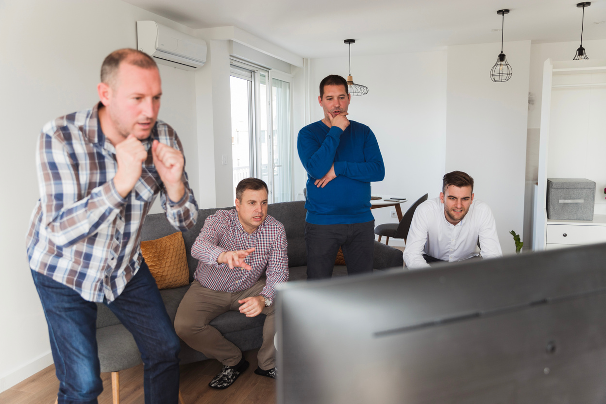 Worried men watching sports live on TV